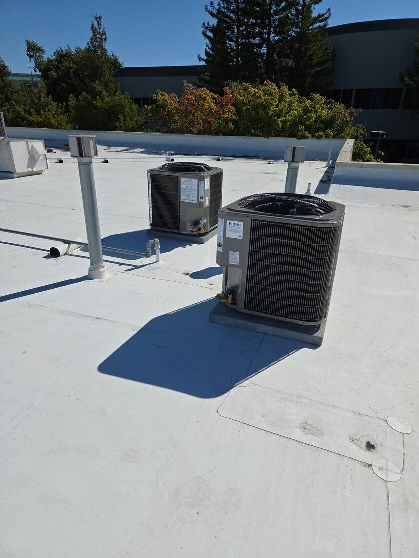 Split-system condenser set on a rooftop curb — HVAC Masters, Vacaville