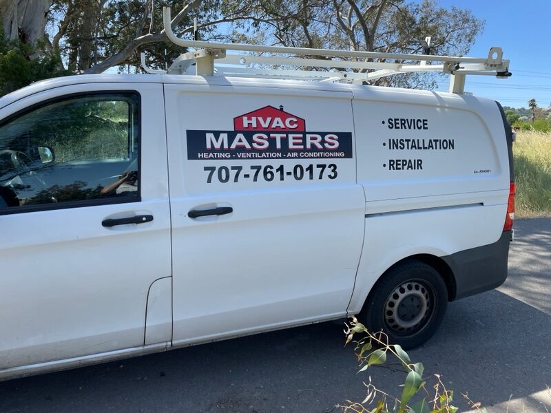 HVAC Masters technician inspecting an outdoor air-conditioning unit